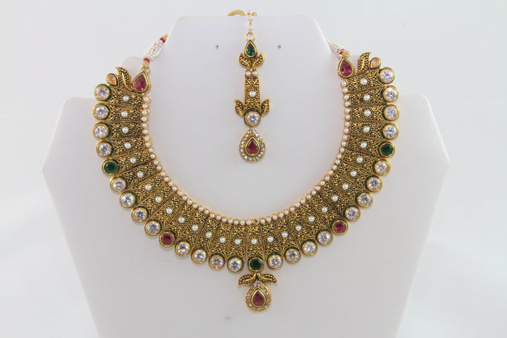 Charming Traditional Gold Kundan Necklace Set with Earrings and Tika